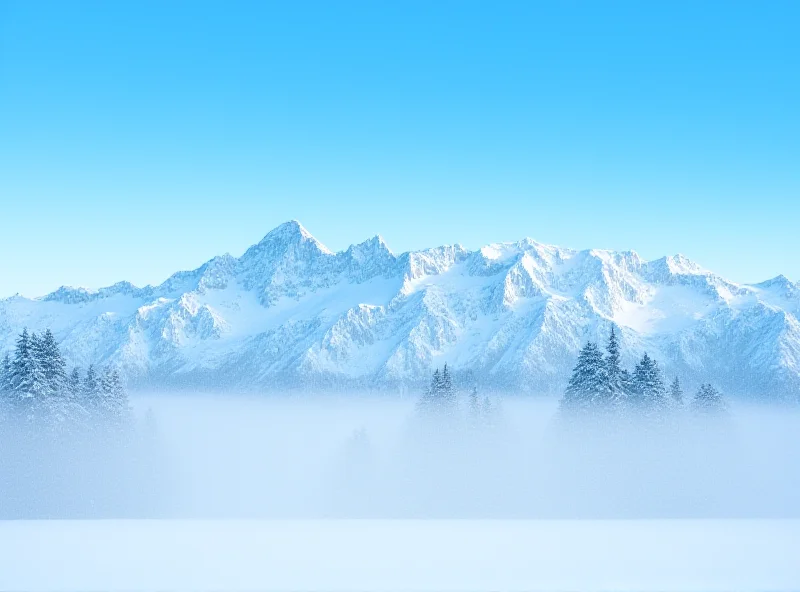 A snowy mountain range in Alaska under a blue sky.