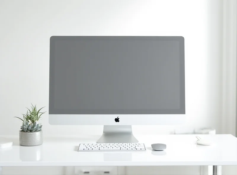 Sleek and modern Apple Mac Studio on a desk with a large display, keyboard, and mouse. The background is a bright, minimalist office space.