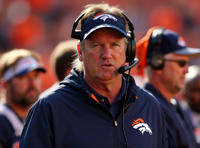 Sean Payton, head coach of the Denver Broncos, standing on the sidelines during a game, looking intently at the field.