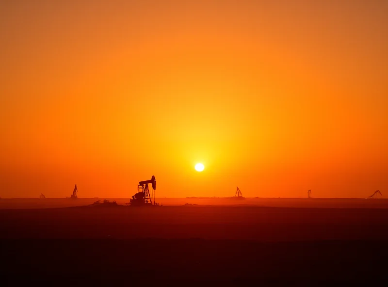 Oil pump in a Venezuelan oil field at sunset.