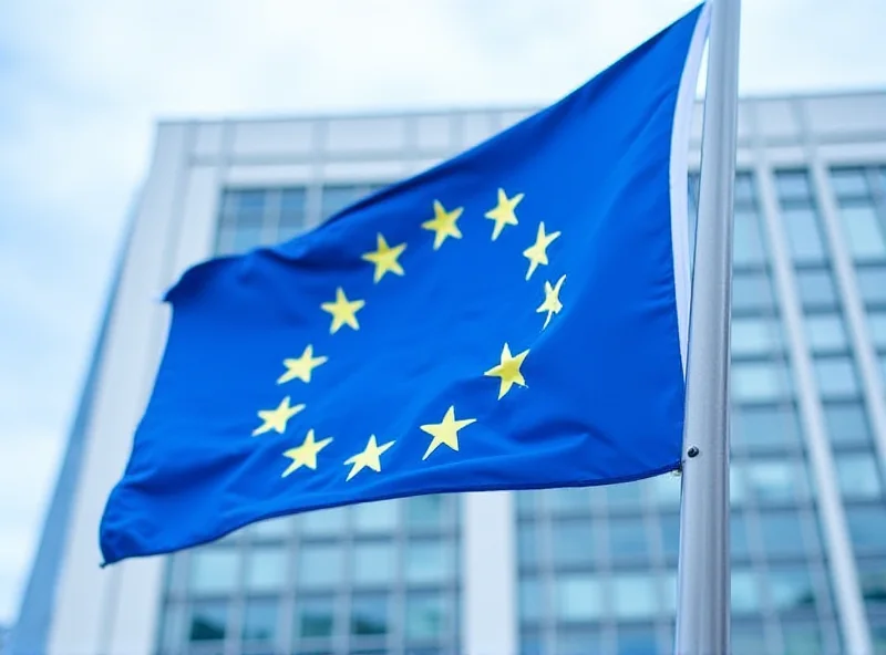European Union flag waving in front of the EU Commission building in Brussels.