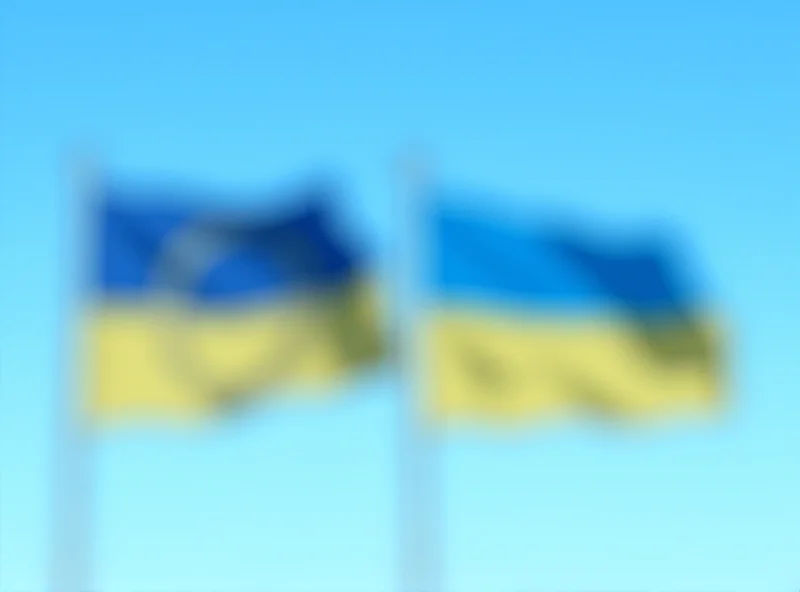European Union flag and Ukrainian flag waving together, symbolizing European support for Ukraine.