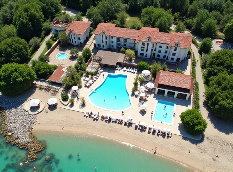 Overview of the Euronat nudist village in France, sunny day, showing the many buildings and people enjoying the grounds.