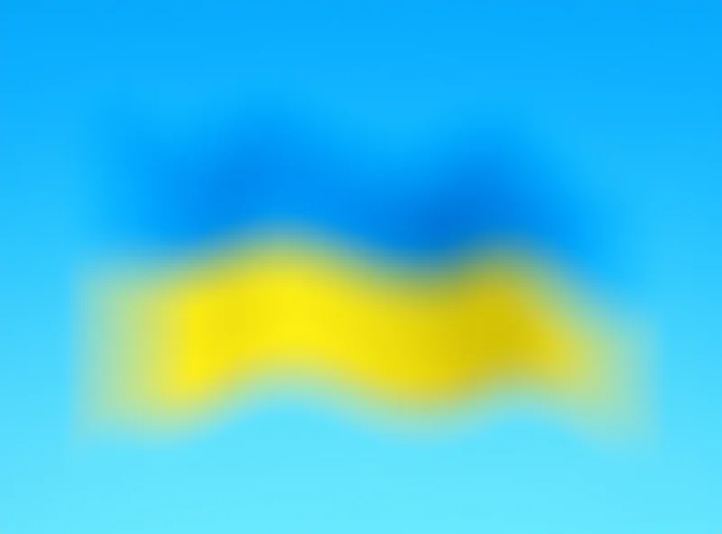 A Ukrainian flag waving in the wind against a blue sky.
