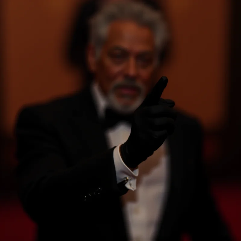 Close-up shot of Morgan Freeman at the Oscars, highlighting the single black glove on his hand.