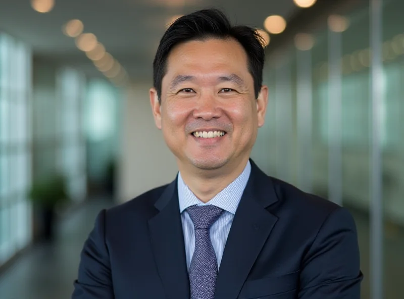 James Li, the new CEO of HONOR, smiling and looking directly at the camera during a press conference.