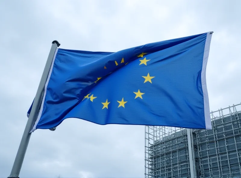 European Union flag waving in front of the European Parliament building in Brussels.