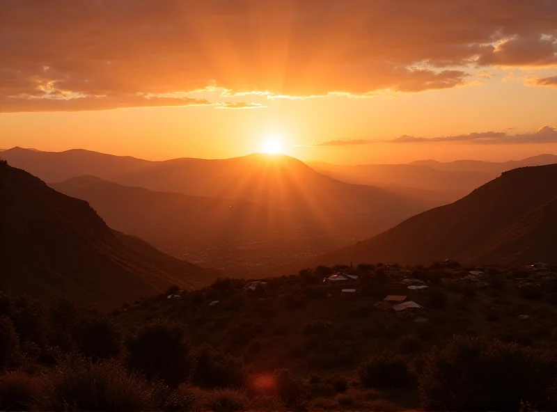 Panoramic view of the mountainous landscape of Lesotho, with traditional Basotho houses in the foreground.