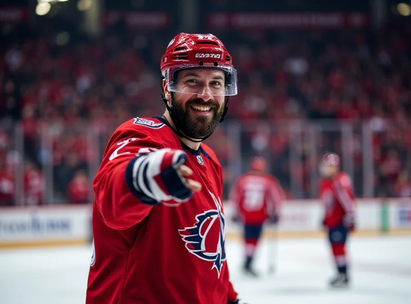 Alex Ovechkin smiling and pointing towards the camera during a game.