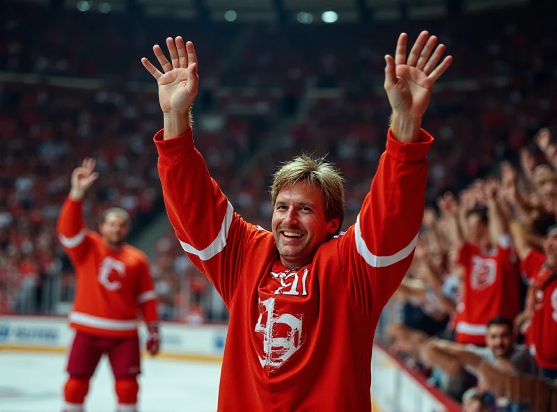 Wayne Gretzky holding up his jersey after a game