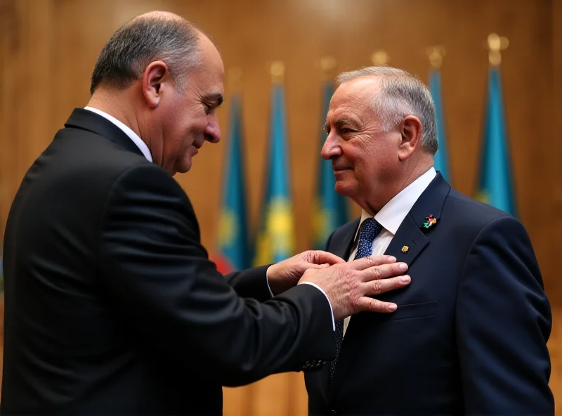 A medal being presented to a man by the president of Kazakhstan.