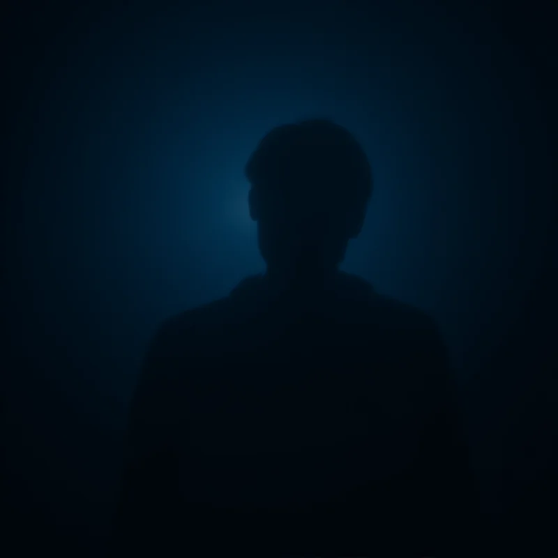 A person sitting alone in a darkened room, illuminated only by the glow of a smartphone, symbolizing isolation and disengagement from the outside world.