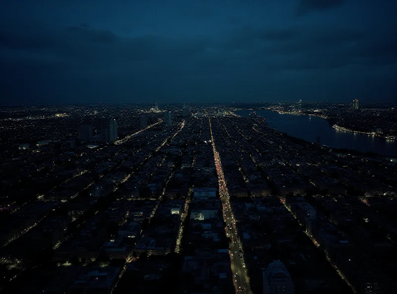 Aerial view of Buenos Aires at night with widespread power outage, only scattered lights visible.