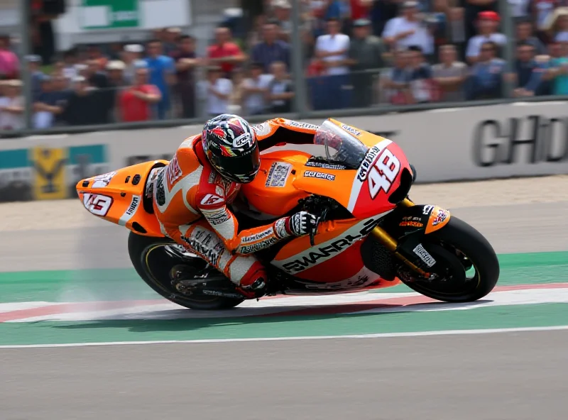 A motorcycle racer speeding down a track during a MotoGP race.