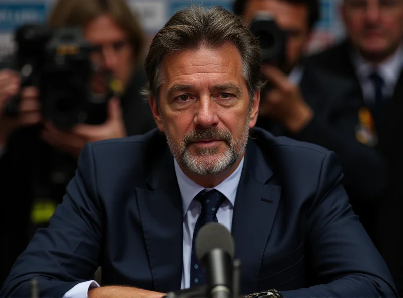 Image of Milan coach Conceiçao looking determined at a press conference.