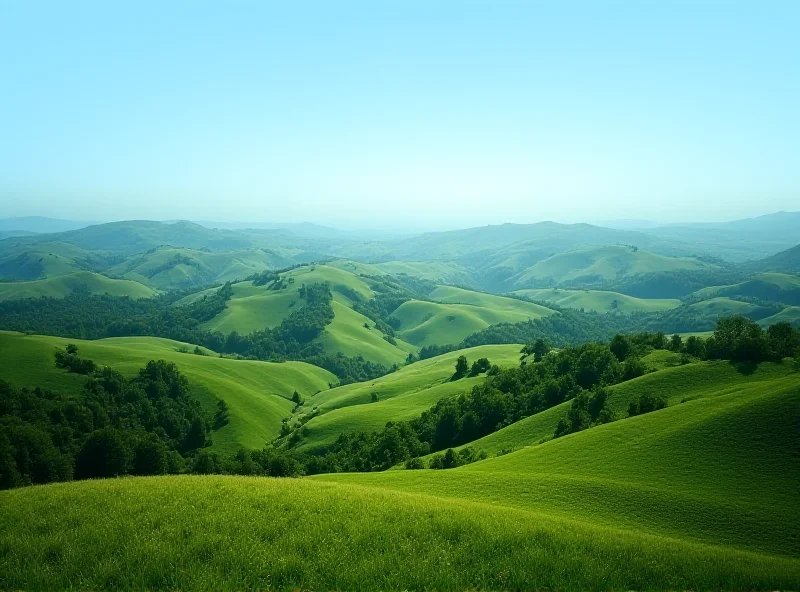 Panoramic view of the Czech Central Mountains, showcasing rolling hills and lush greenery under a clear blue sky.