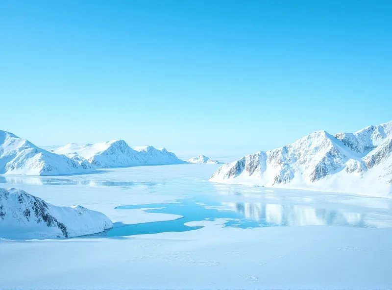 Photo of Greenland landscape, snow-covered mountains and icy fjords under a bright blue sky.