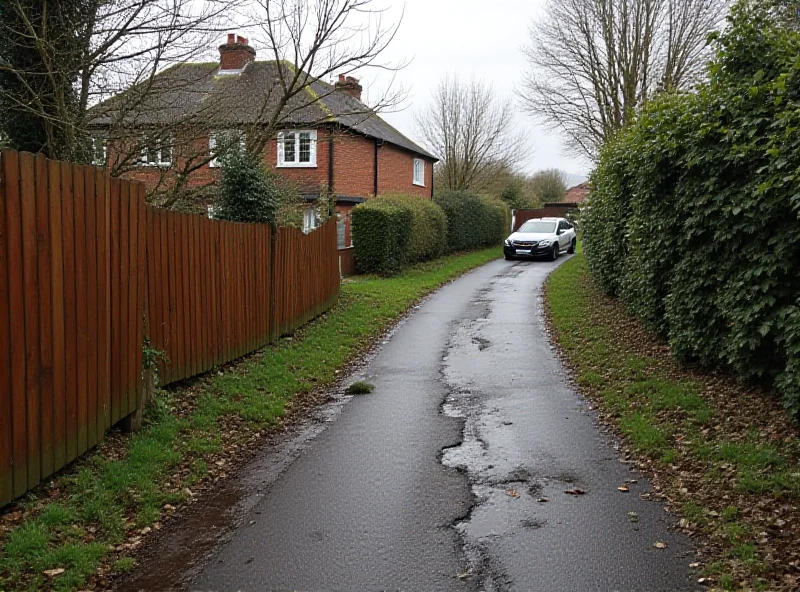 A damaged fence and car on a narrow country road, illustrating the dangers caused by large vehicles.
