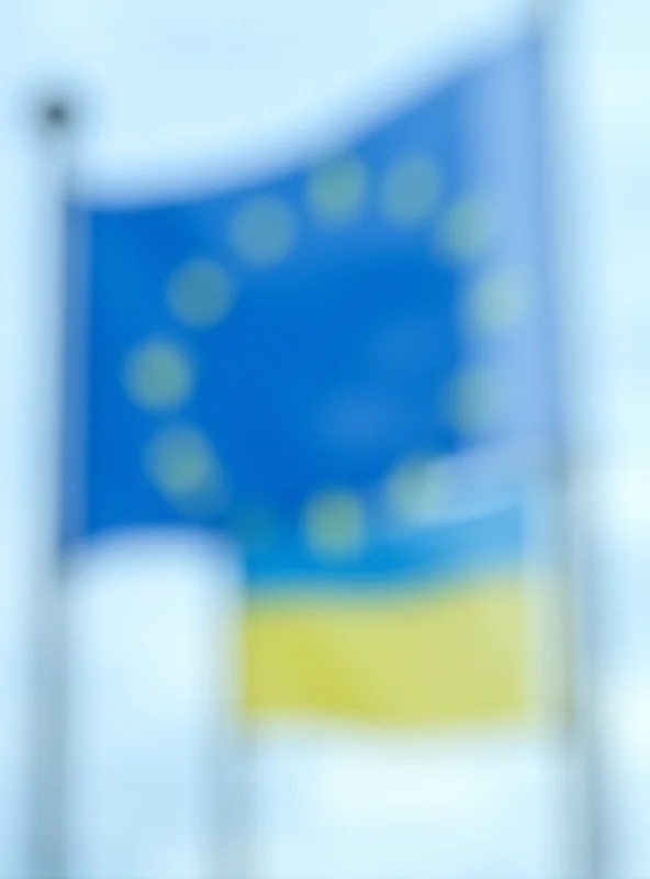 European Union and Ukrainian flags waving in the wind.