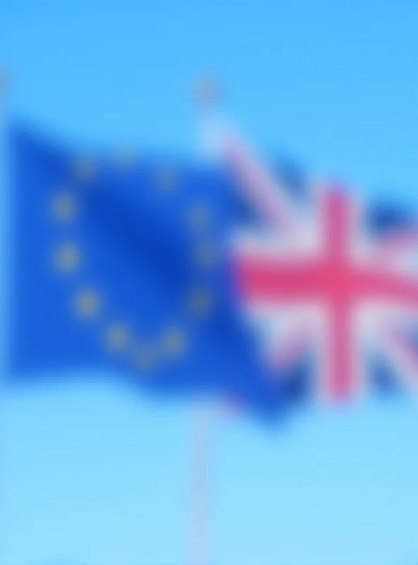 European Union and United Kingdom flags waving side by side.