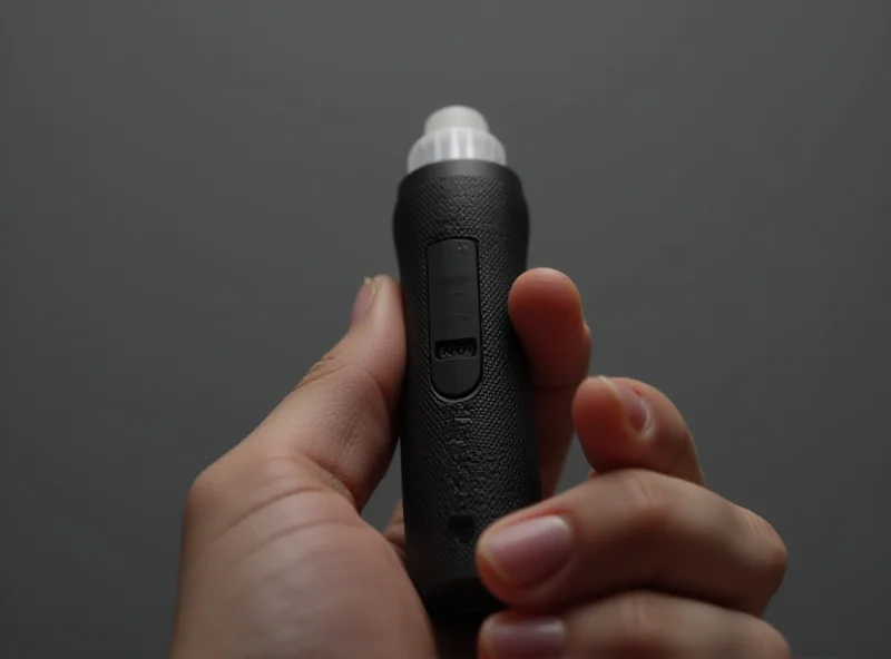 Close-up shot of the Theragun Mini Gen 3, showcasing its compact design and ergonomic grip.